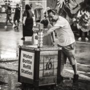 man refilling water bottle