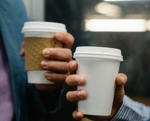 Two-hands-holding-takeaway-cups