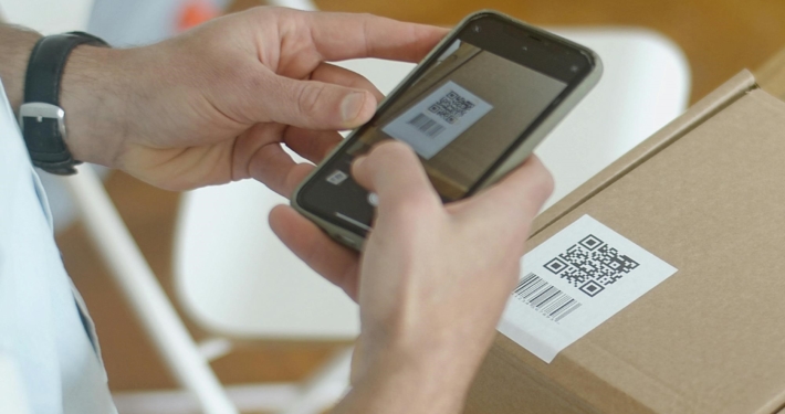 person-scanning-QR-code-on-packaging