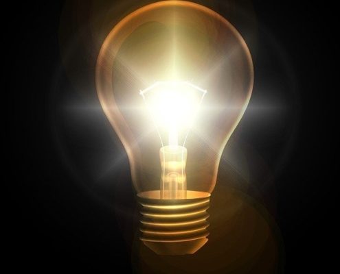 lightbulb-lit-against-dark-background